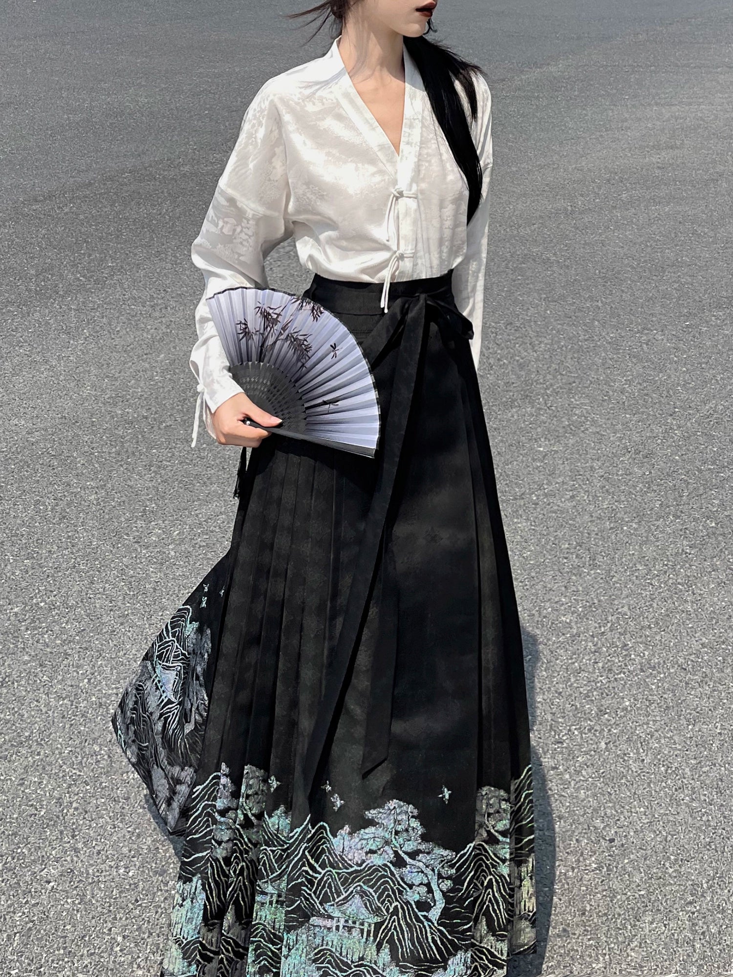 Explore modern elegance with our Black & White Shirt Women's Horse Face Skirt Suit. This ensemble blends traditional Hanfu design with contemporary flair, featuring intricate embroidery and authentic details. Embrace the timeless beauty of Hanfu fashion and make a statement with your unique style.